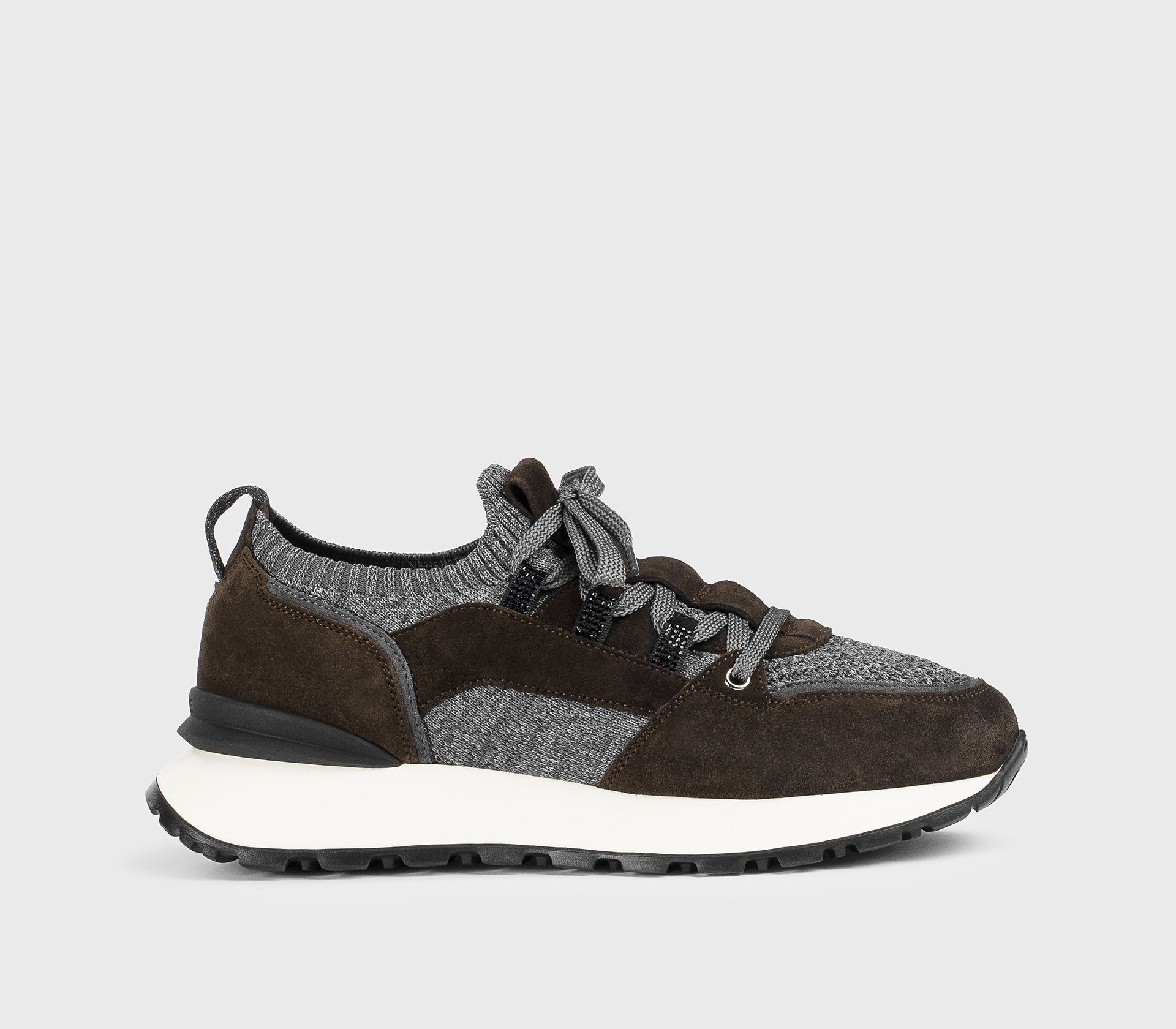 Brown and grey sneaker made from a combination of materials