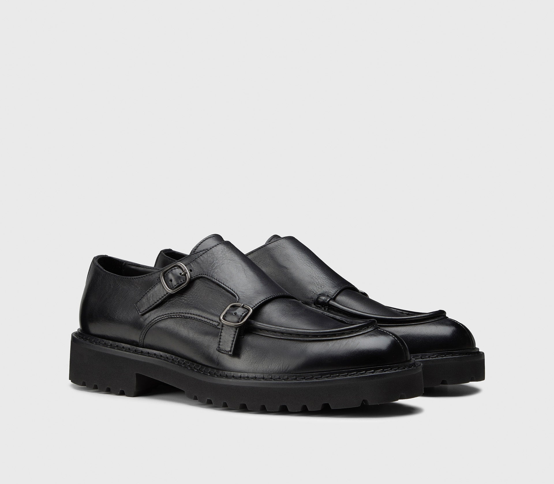 Black leather double-buckle shoe.